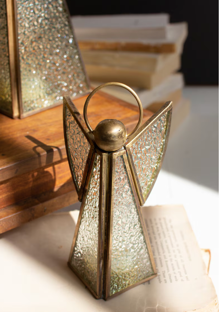 Lifestyle shot of small angel on open book with warm glowing glass
