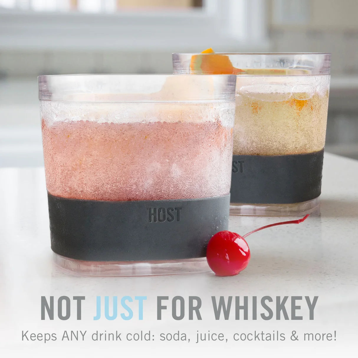 Two glasses with drink contents and a cherry on a white surface, with 'HOST' branding.