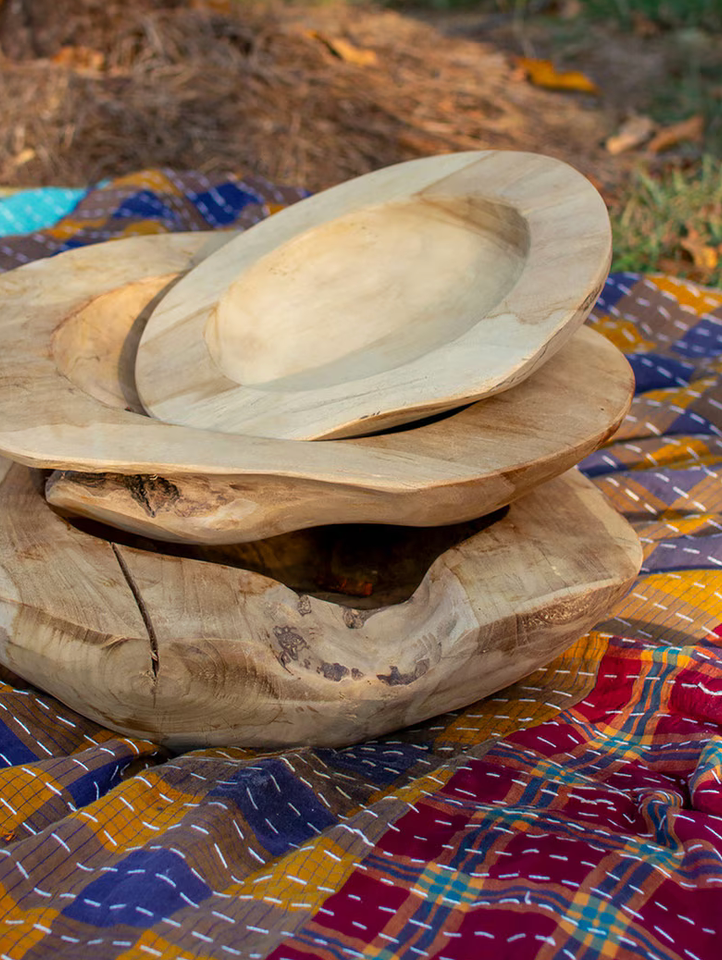 Stack of wooden plates on a colorful fabric background