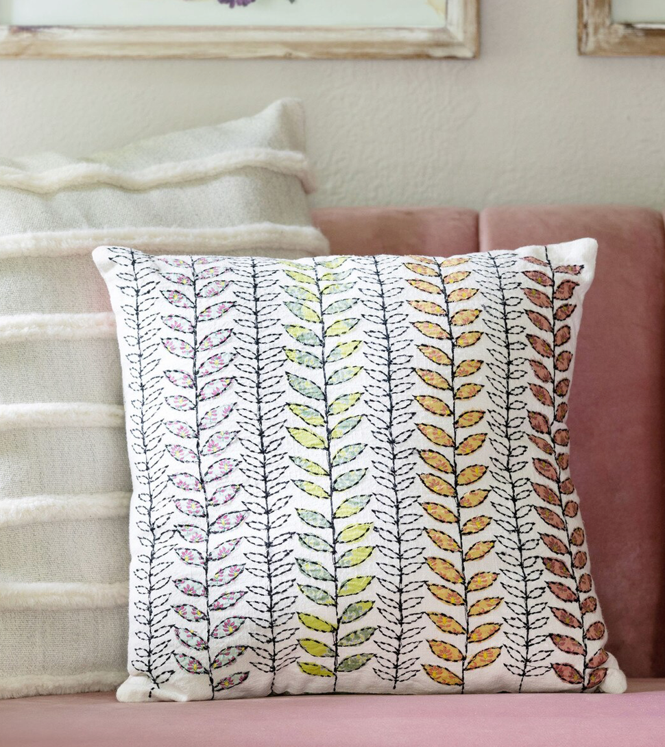 Decorative pillow with leaf pattern on a couch