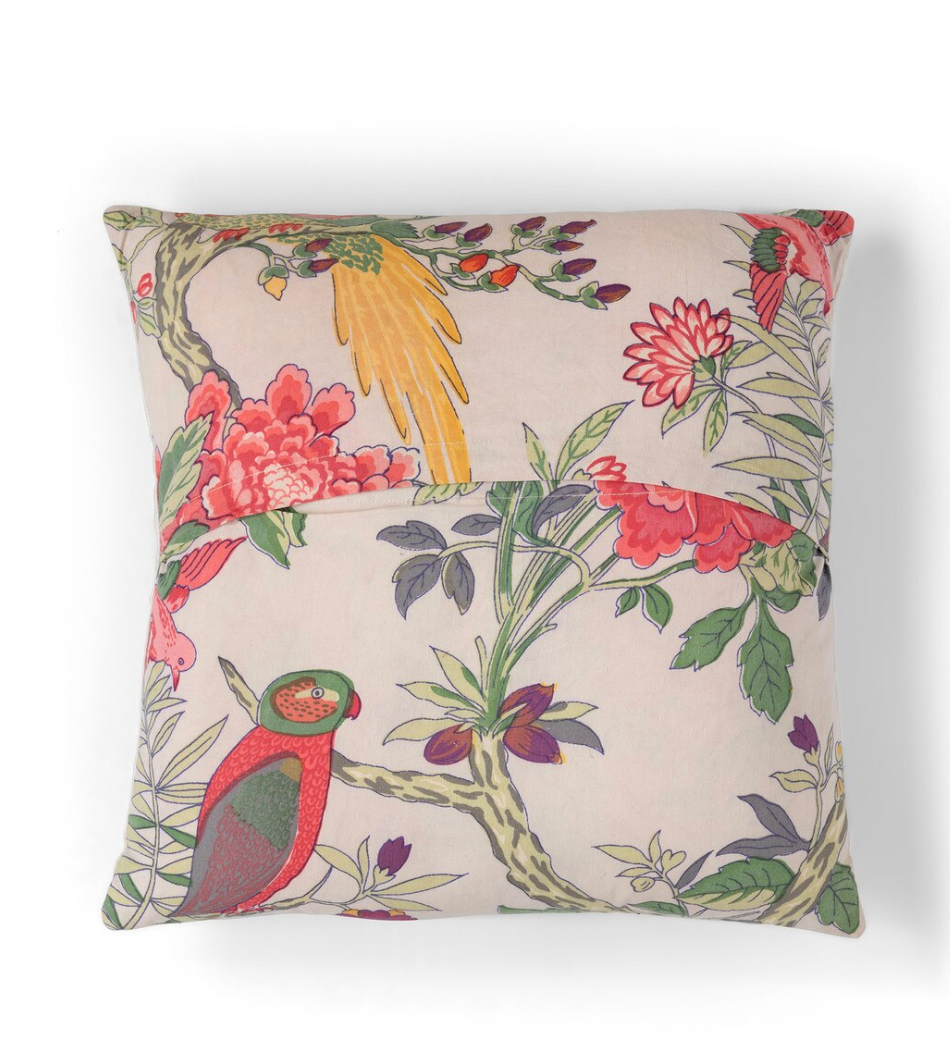 Decorative pillow with tropical bird and floral pattern on a beige background