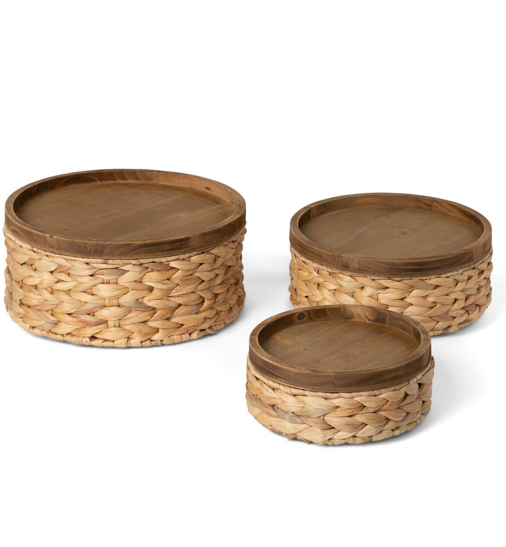Three woven baskets with wooden lids on a white background