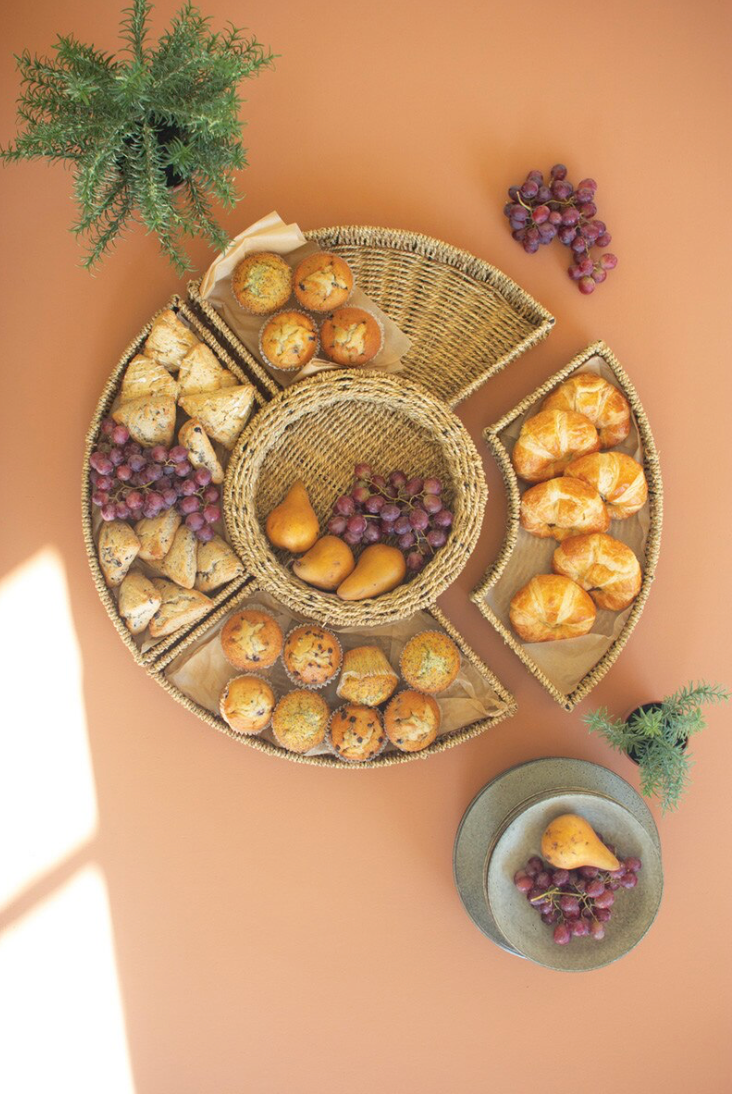 Woven tray with bread and grapes on a beige background