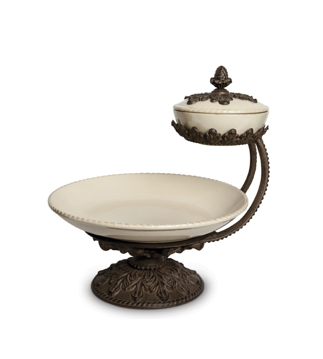 Decorative white dish with bronze stand and lid on a white background