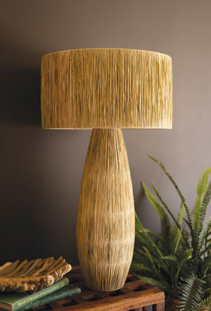 Decorative lamp with a textured design on a wooden surface against a dark background