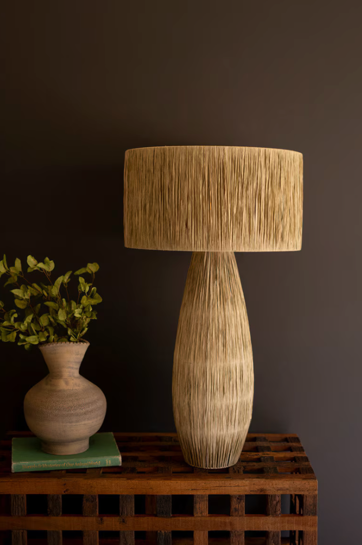 Textured table lamp on a wooden pallet with a dark wall background