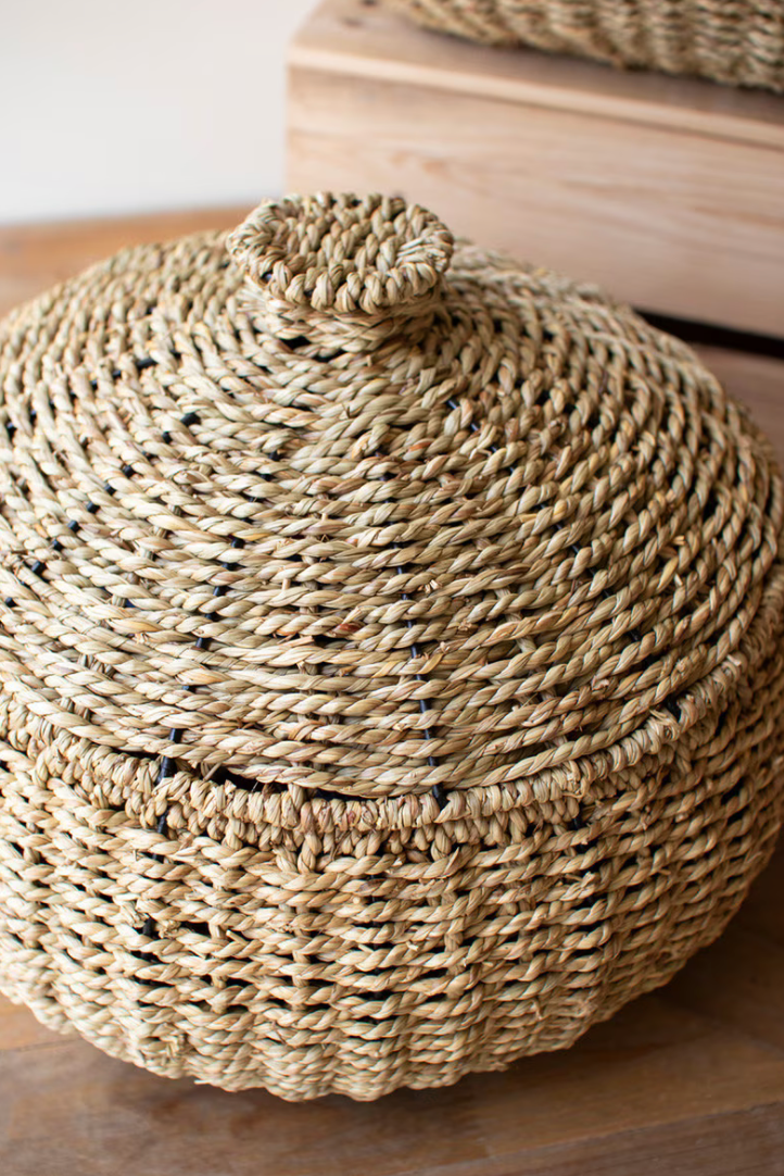 Woven basket with a lid on a wooden surface