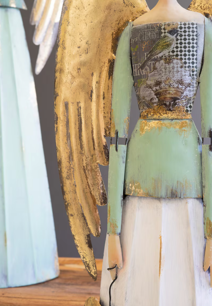 Side detail of gold wing, dress layers, and articulated arm