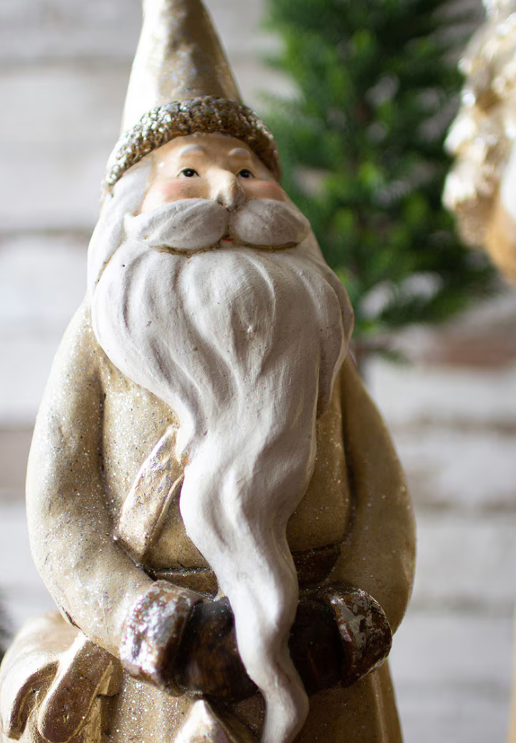 smaller Santa figure with a off white coat and long white beard
