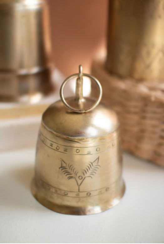 "Set of 3 Antique Brass Finish Bells styled in a holiday vignette on a shelf or mantel showing graduated sizes and rich brass finish"