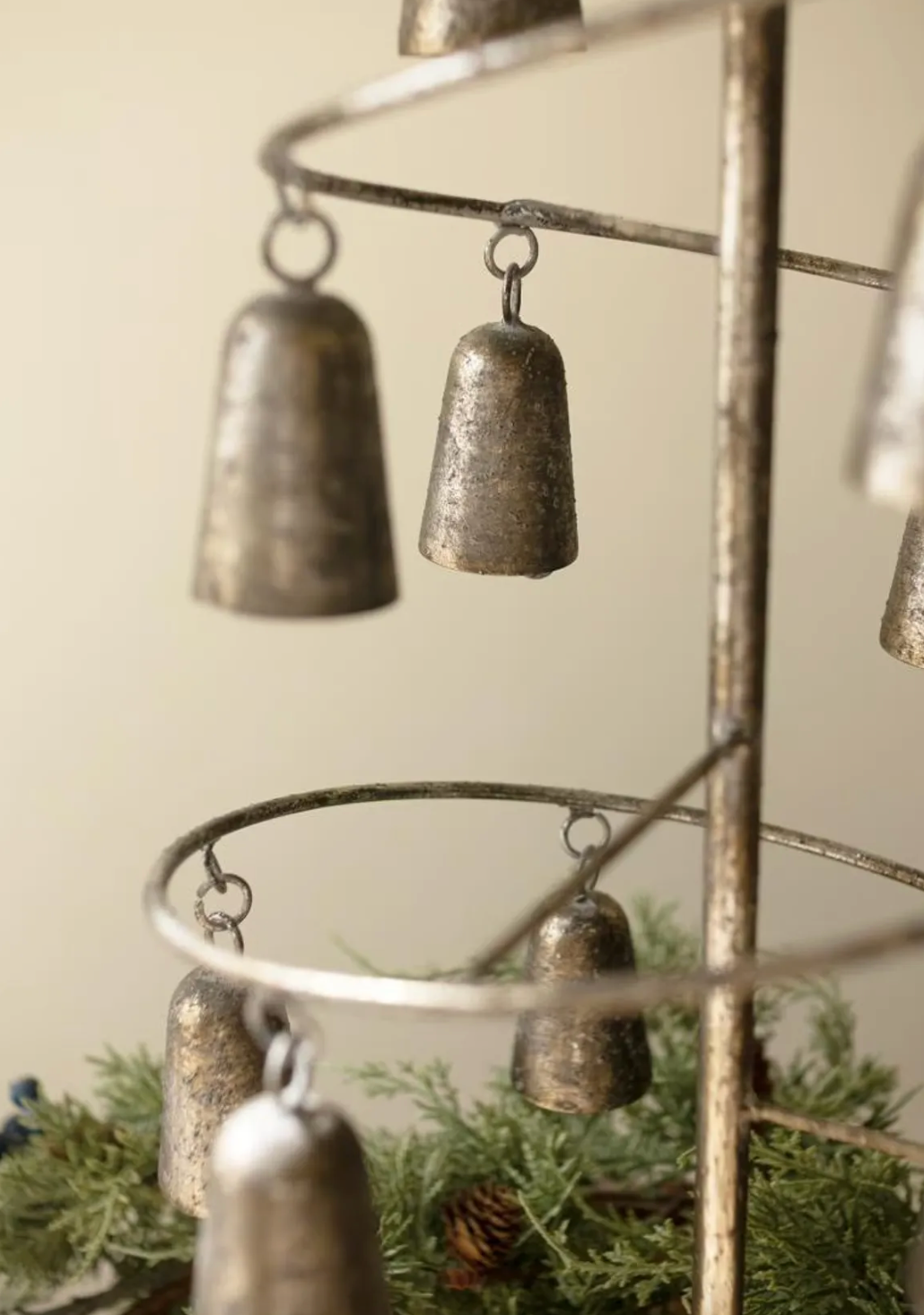 Close up of metal bells on tree. 
