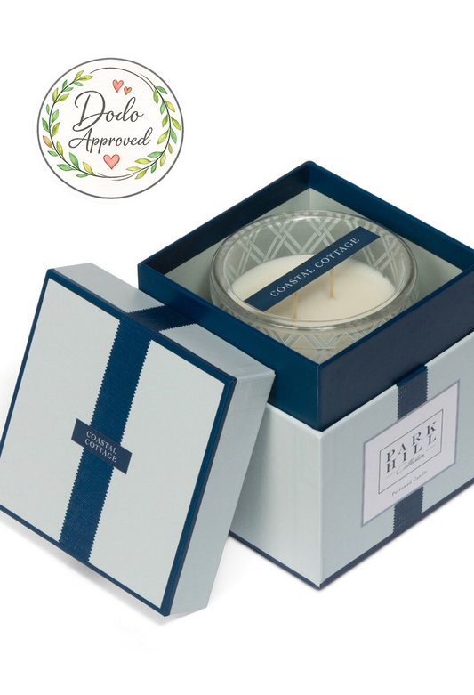 Candle in a decorative box with 'Dodo Approved' label on a white background