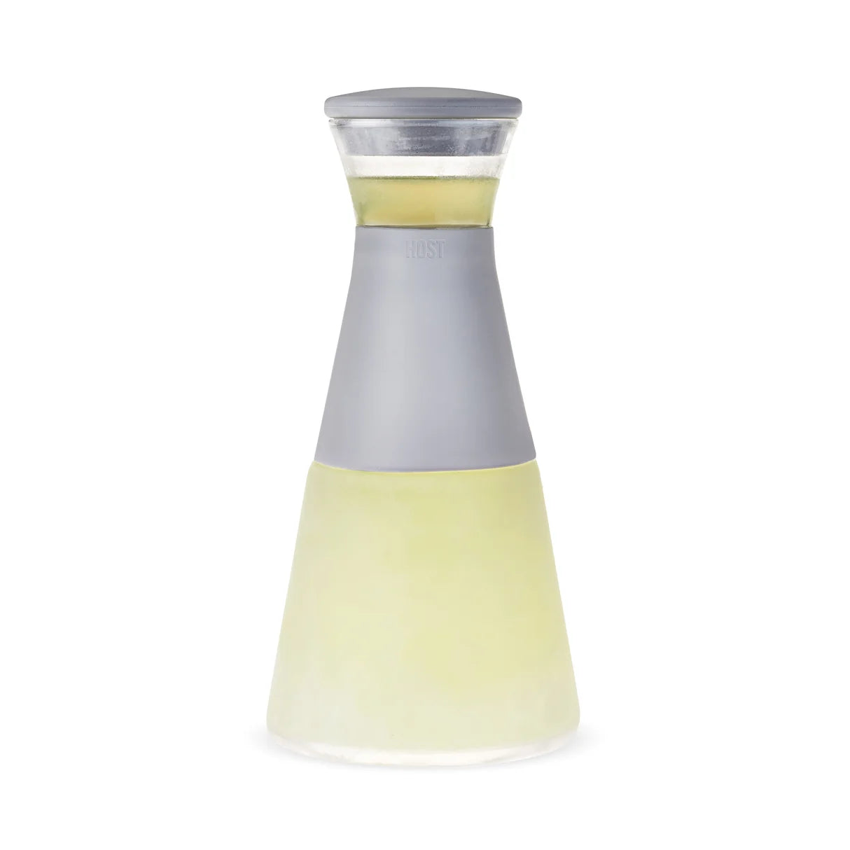 A modern glass carafe with a matte gray silicone middle section and a clear lid, filled with pale yellow liquid, shown on a white background.