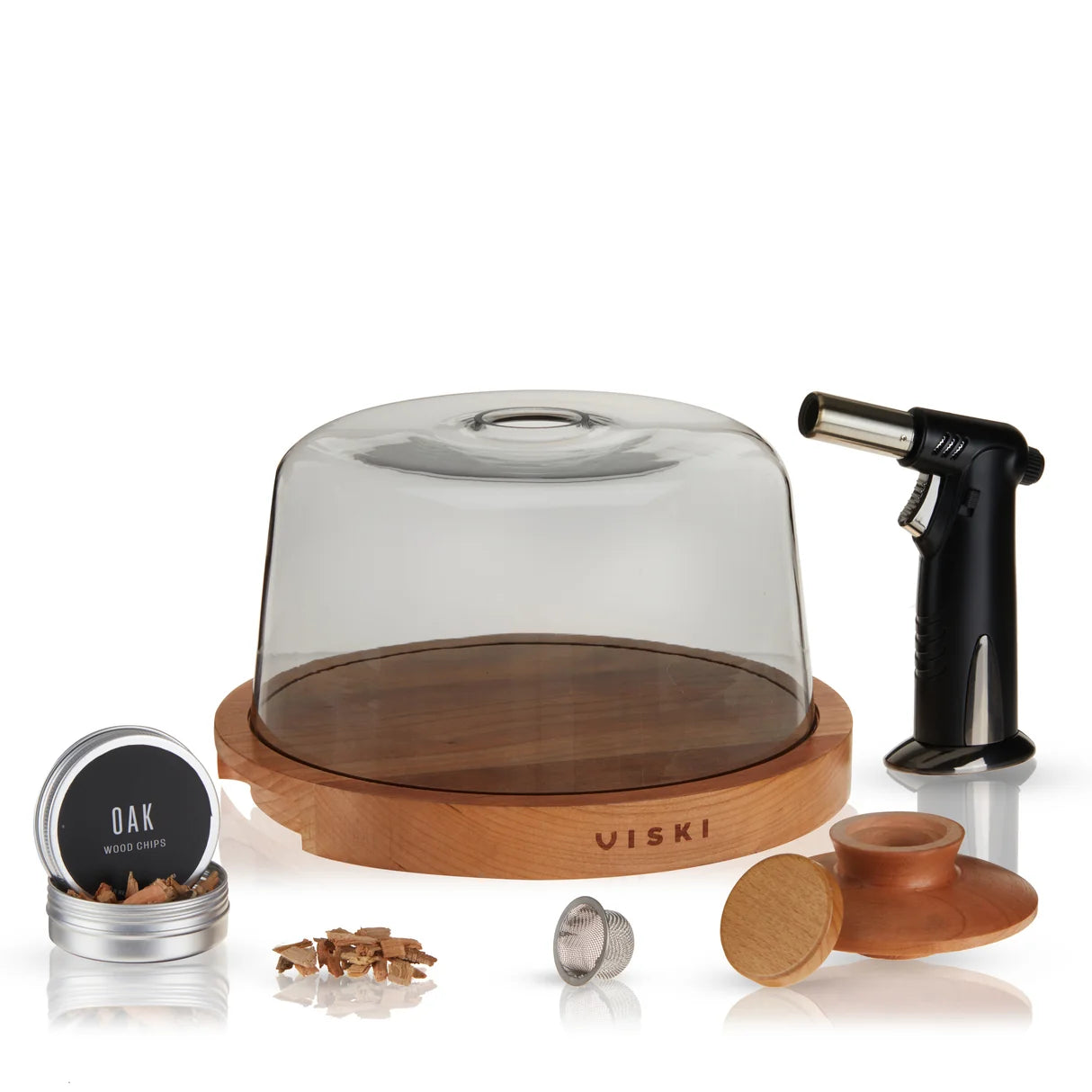 Viski wood smoke flavoring kit on a white background, including a glass dome over a wooden base, a black torch lighter, a small tin labeled Oak Wood Flavors, wood chips, metal wick pieces, and a wooden diffuser.