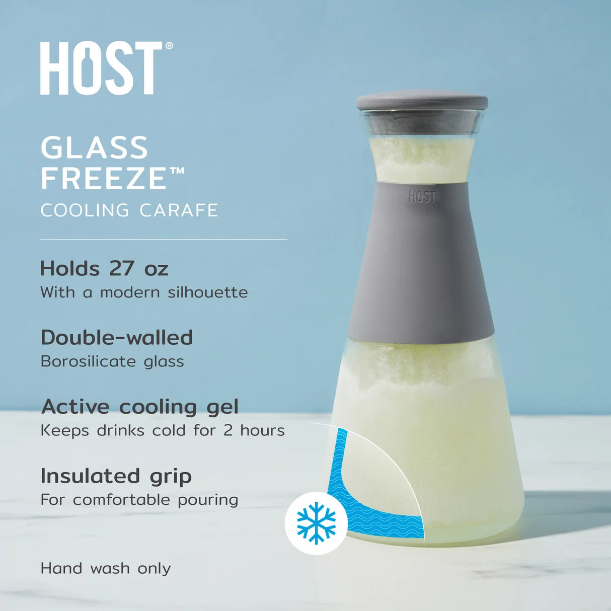 HOST Glass Freeze cooling carafe with a gray silicone grip and frosted glass body, shown on a light blue background with product text and feature callouts.